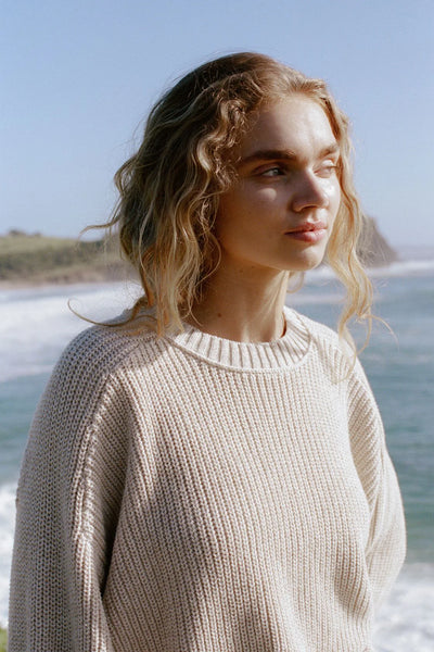 A close-up of the textured cotton knit, highlighting the "mottled" blend of cream and sand yarns that create a multidimensional, speckled color effect.