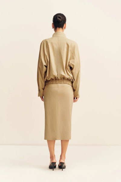 Rear full-length view of a model showcasing the elasticated waistband, raglan sleeve construction, and back panel detailing of the Shona Joy Ernest bomber jacket in sand.