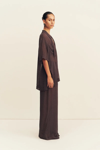 A close-up portrait view focusing on the upper bodice, emphasizing the structured collared neckline with the long georgette neck tie detail left loosely untied at the front.
