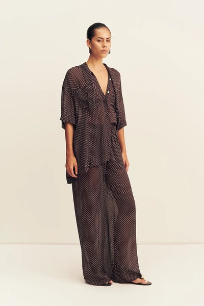 A front portrait studio view focusing on the upper half of the pants, showcasing how the gathered elastic waistband sits comfortably on the waist with its matching adjustable tie.