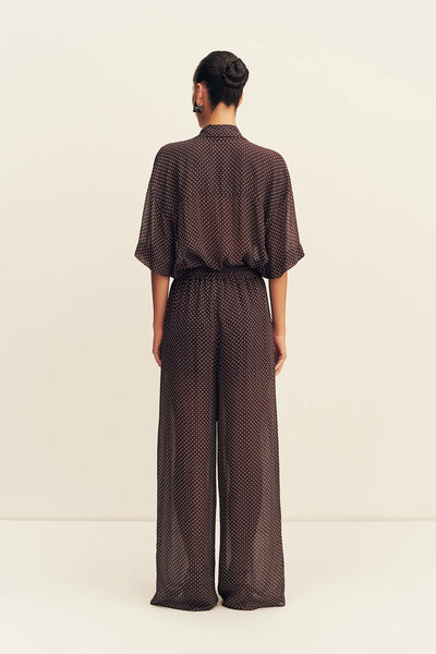 A three-quarter side angle view emphasizing the breezy, relaxed fit through the leg and the delicate sheer quality of the woven viscose fabric.