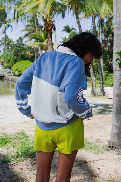 A full-length front view of the sailing jumper on a model, highlighting the slouchy vintage sports fit, the dropped shoulders, and the casual drape of the 300gsm cotton fleece.