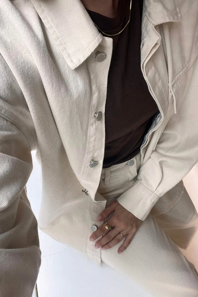 A close-up of the "Coconut" fabric, highlighting the natural seed-flecked appearance of the 100% organic cotton twill.