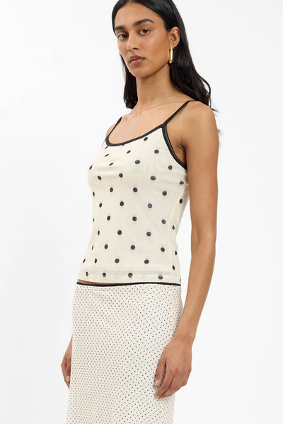 An angled close-up campaign shot of the printed camisole bodice, illustrating the slightly sheer qualities of the mesh panel overlay and its close-to-silhouette fit.