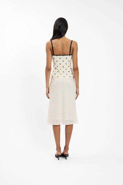 A close-up campaign shot focusing on the midsection, detailing the contrasting black scallop elastic waistband against the ivory mesh fabric base.
