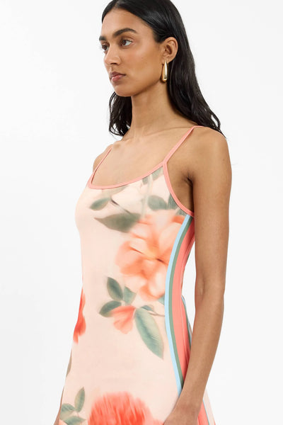 A structured side-angle studio image emphasizing the seamless flow of the exclusive peach floral artwork from the bodice through the hips.