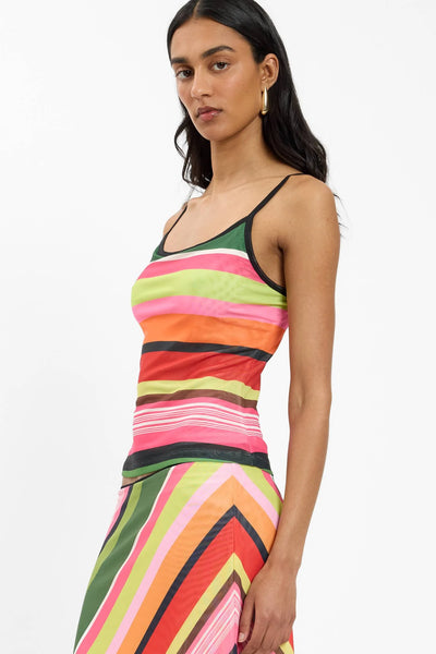 A side profile campaign shot emphasizing the mid-waist cropped hemline of the pull-over camisole top, illustrating its close-to-silhouette tailored fit.