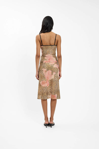 A full back view of the leopard print midi skirt on a model, highlighting the smooth pull-over fit, seamless pattern continuity, and delicate black scallop elastic detailing at the waistband.