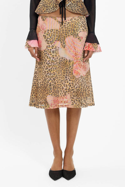 A close-up, mid-torso framing of the skirt’s waistband and the lower half of the matching camisole, focusing on the fabric texture and dark trim contrast.
