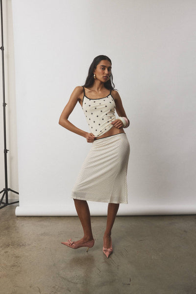 A full-length  view of the ivory polka dot co-ord ensemble, highlighting the smooth, hardware-free pull-on fit across the lower back and seat.
