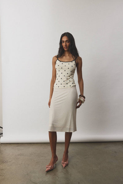 A full back studio view of the complete polka dot camisole and midi skirt outfit, highlighting the smooth, hardware-free fit of the pull-over styling.