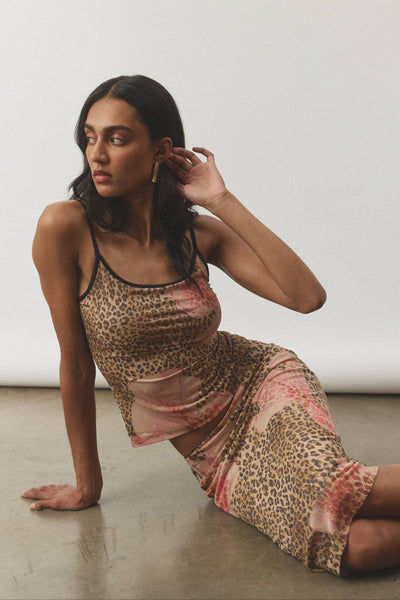A clean, full-length front studio profile showing the midi skirt’s mid-waist placement, smooth fit through the hips, and slight flare towards the hemline.