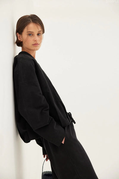 Model wearing the Rae Pant, illustrating the clean, relaxed line through the leg and the effortless, "easy fit" design on a 175.5cm frame.