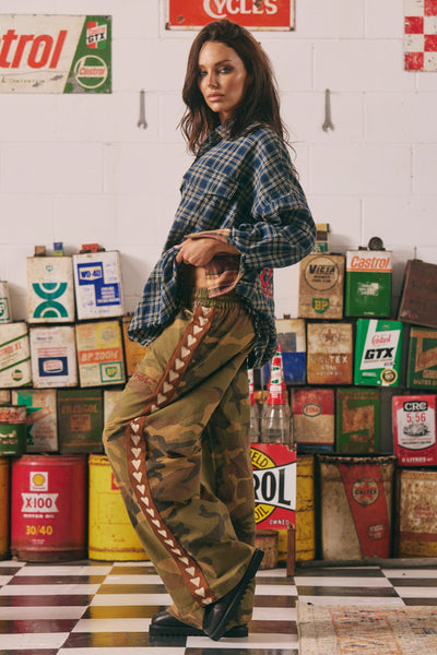 A dynamic, walking-angle lookbook shot demonstrating how the non-stretch washed canvas fabric holds its bold, structured shape during movement.