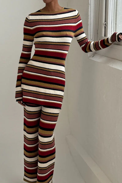 Model wearing the fitted Earth Stripe mini dress, showcasing the high neckline and the effortless drape of the cotton-linen blend.