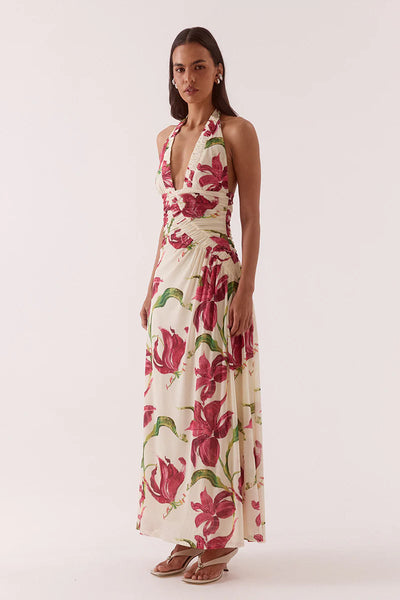 A full-length side profile view of the cream mesh maxi gown, highlighting the fluid drape of the long column skirt and the continuous side-seam ruching detail.