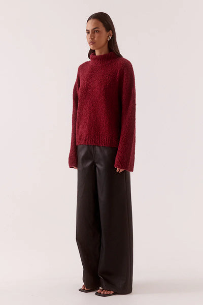 A rear close-up shot highlighting the seamless construction of the high mock neck collar and its sturdy ribbed border.