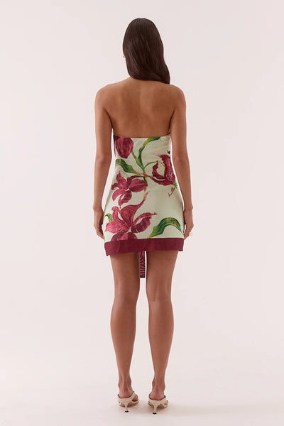A full-length back studio view of the cocktail mini dress, demonstrating the high halter neck button closure and the clean fit of the elasticated upper back edge.