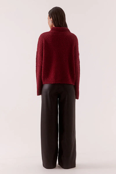 A full back view of the Raspberry Wine Verse Sweater on a model, emphasizing the clean shoulder line and the uniform drape of the heavy textured loop yarn knit.