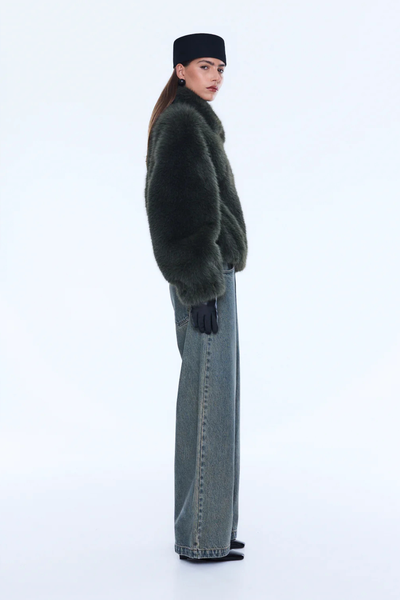 Side-back profile of the olive bomber, showcasing the fully lined interior and the thick, insulating quality of the plush recycled polyester.
