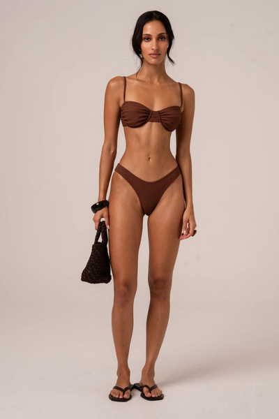 A full-length front studio shot of a model wearing the Ochre Lane 80's Brief Bottom in Choc Rib, showcasing the nostalgic high-cut leg openings and a comfortable fit at the lower waist.