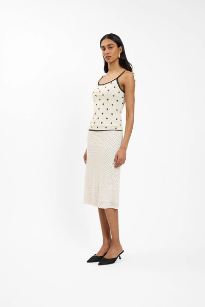 A studio image focused from the hips down, illustrating the soft drape, comfortable stretch lining, and elegant mid-calf length of the mesh separate.