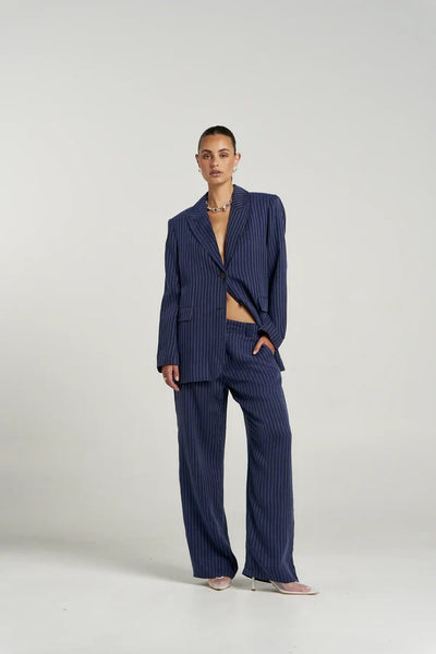 Full-body front shot of model wearing the oversized Summi Summi Navy Pinstripe OS Blazer set with hand in trouser pocket.