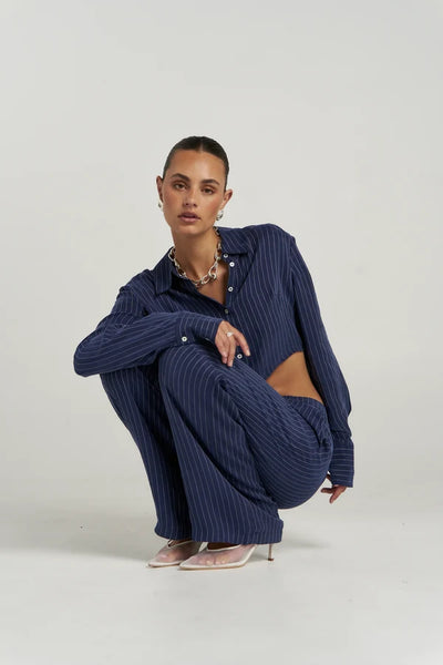 Full-length front view of model wearing the navy pinstripe wide-leg Summi Summi Boss Pant paired with the matching OS Blazer set and pointed mesh heels.