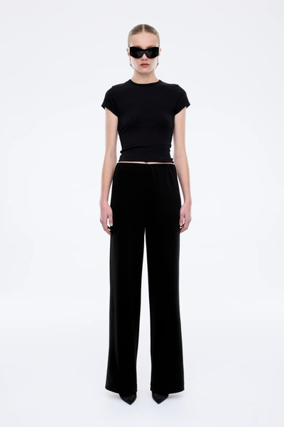 Relaxed wide-leg Alessa pants in black, featuring a comfortable elasticated waistband and a fluid, floor-length silhouette.