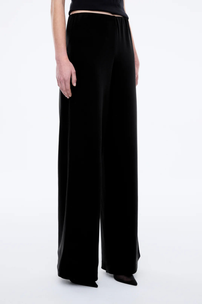 Model wearing the Alessa wide-leg pants, illustrating the flattering high-rise fit and the generous, loose cut through the leg on a 179cm frame.