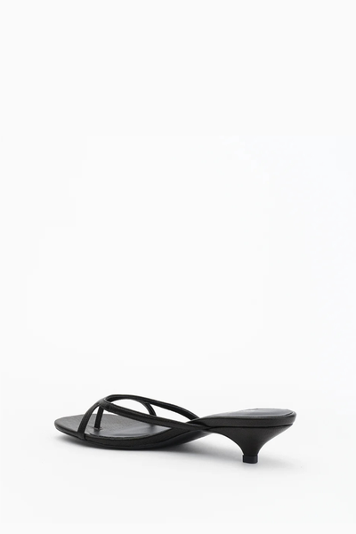 Side profile view of the Alias Mae Bodie sandal in black tumble, featuring a walkable 4cm kitten heel and slim crossover leather straps.