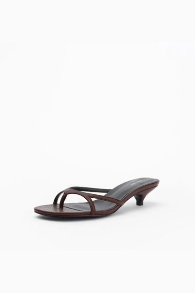 Side profile studio view of the brown leather strappy mule, highlighting the slip-on open-toe design and low block heel.