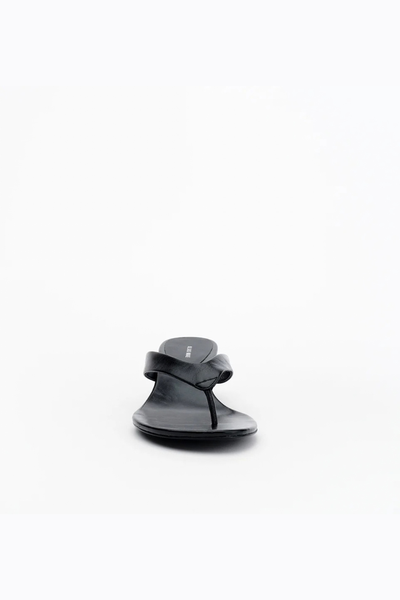 Front-facing shot of the black thong sandal, emphasizing the slim toe post and rounded toe shape against a plain white background.