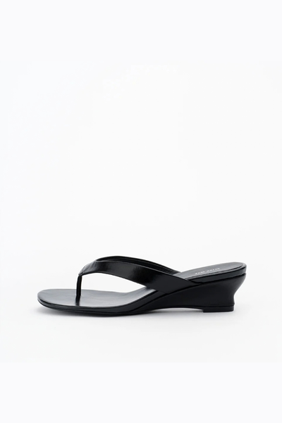 Side profile view of the black leather wedge sandal, showcasing the arch support and the gradient height of the 45mm heel.
