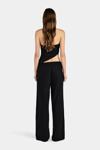 Studio rear full-length view of a model wearing relaxed black linen-blend straight-leg pants featuring an elasticized drawcord waist.