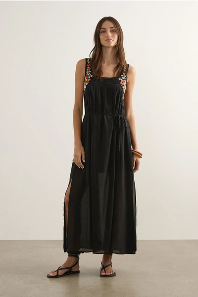Studio front full-length view of a model wearing the black Amiah maxi dress styled with a removable waist tie, showing the relaxed, floaty shape.