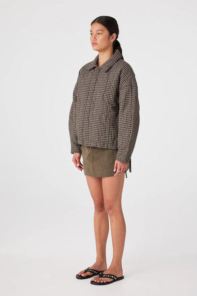 A side profile view of the jacket, showcasing the dropped shoulders and the rounded, oversized volume of the sleeves.