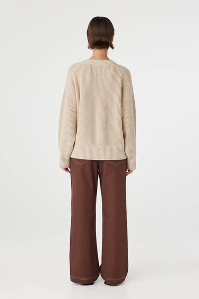 back profile highlighting the sweater's generous volume and the breathable, organic feel of the heavy-knit cotton.