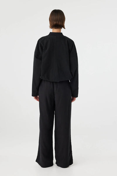 Back profile highlighting the lightweight, breathable nature of the cupro blend and the relaxed, non-restrictive fit through the seat and thighs.