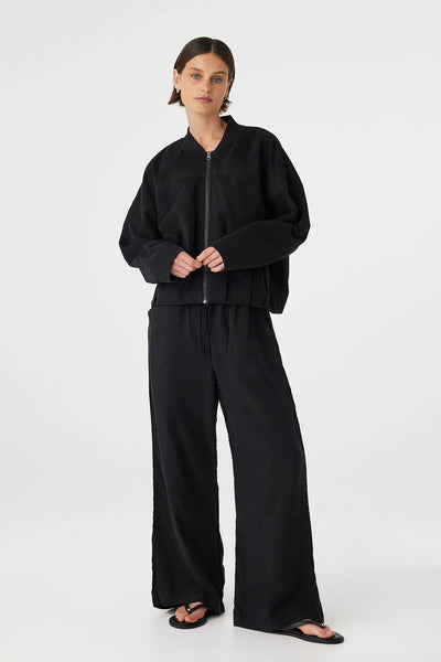 A minimal black Wren Bomber Jacket featuring a relaxed silhouette, a classic ribbed collar, and a polished exposed front zipper.