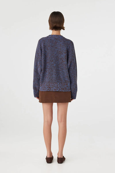 A direct full-length back profile view showing the uniform color blending of the bi-color marled knit and how the hem rests comfortably below the hips.