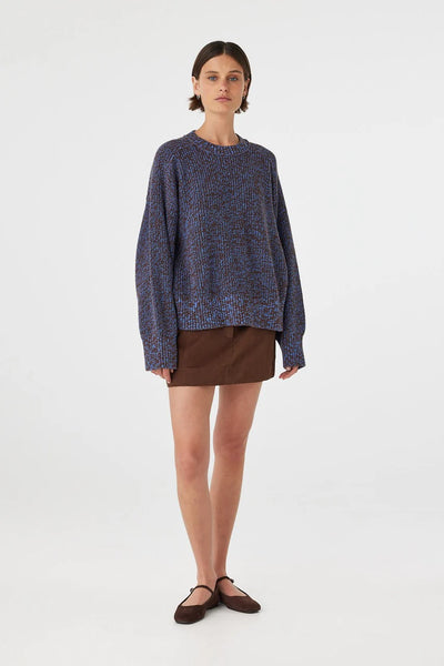 A three-quarter back studio view of the Solene knit sweater, demonstrating the fluid drape across the shoulders and upper back.