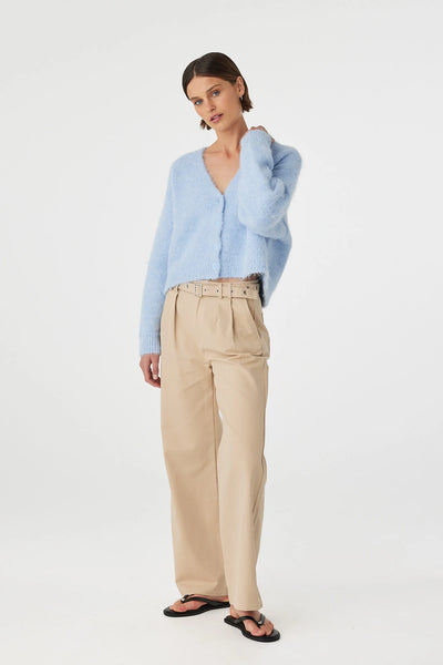 Studio portrait of a model modeling the Sky blue Liora Fluffy Cardigan by Arcaa Movement. The image highlights the relaxed silhouette, dropped shoulder architecture, and the rich, fuzzy knit texture of the recycled polyester and wool blend fabric.