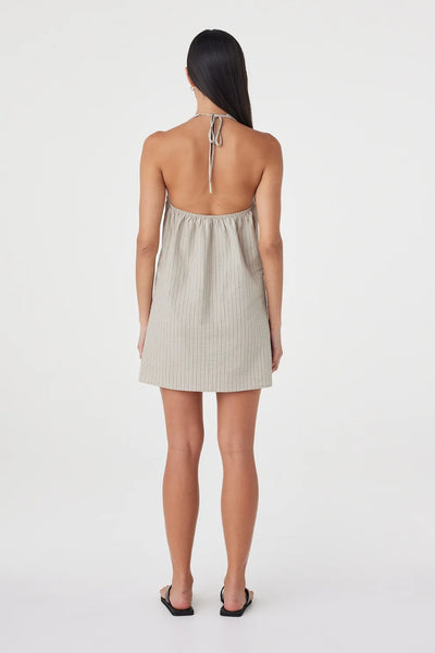 Full-length back view highlighting the open back design, halter tie closure, and relaxed gathering through the upper back.
