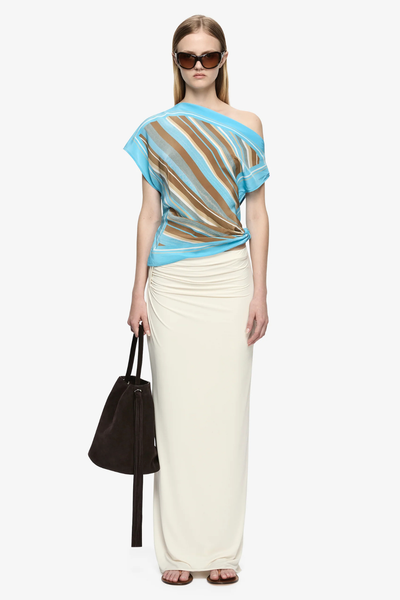 Full-body front angle showcasing the asymmetric drape and overall resort-ready styling.