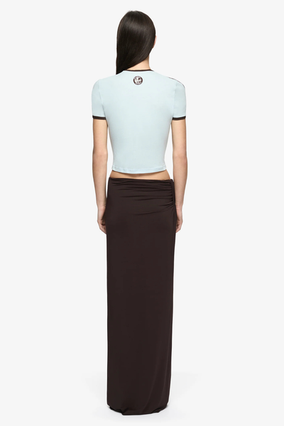 Full-body back view of the Solara Tee showing the cropped fit and back neckline patch detail.