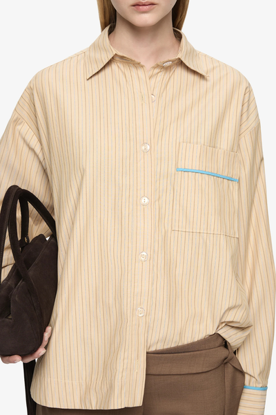 Close-up front view highlighting the tan striped fabric, collar, and button details.