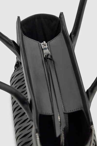 Top-down view of the black Brie Leon Faye Mini Tote highlighting the top zip closure with extended leather pull tab and structured dual top handles.