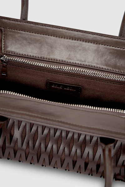Interior detailed shot of the Brie Leon Faye Mini Tote in ganache, displaying the dark brown cotton twill lining, interior zip pocket, silver hardware, and debossed logo patch.