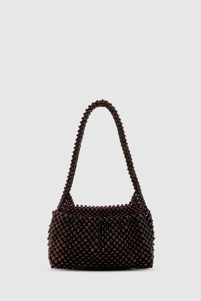 Studio front-facing product shot of the dark chocolate lotus wood beaded mini bag against a clean white background, highlighting its compact, structured silhouette and sculptural top handle.